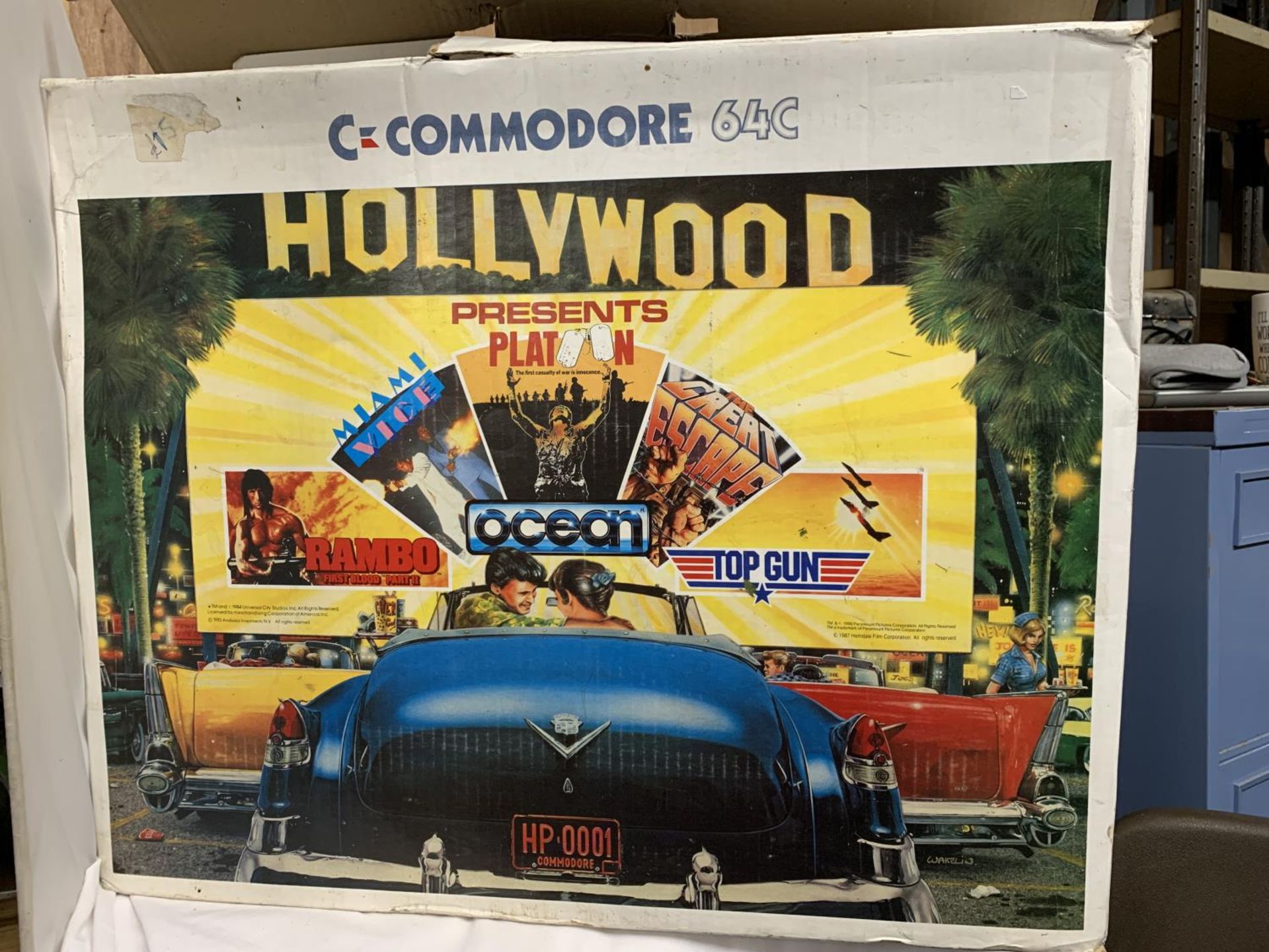 A BOXED COMMODORE 64C COMPUTER BUNDLE TO INCLUDE CASSETTE UNIT, JOYSTICK, HOLLYWOOD GAMES SUCH AS