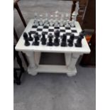 A MODERN PAINTED CHESS TABLE COMPLETE WITH FULL SET OF PIECES