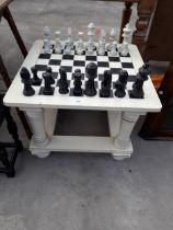 A MODERN PAINTED CHESS TABLE COMPLETE WITH FULL SET OF PIECES