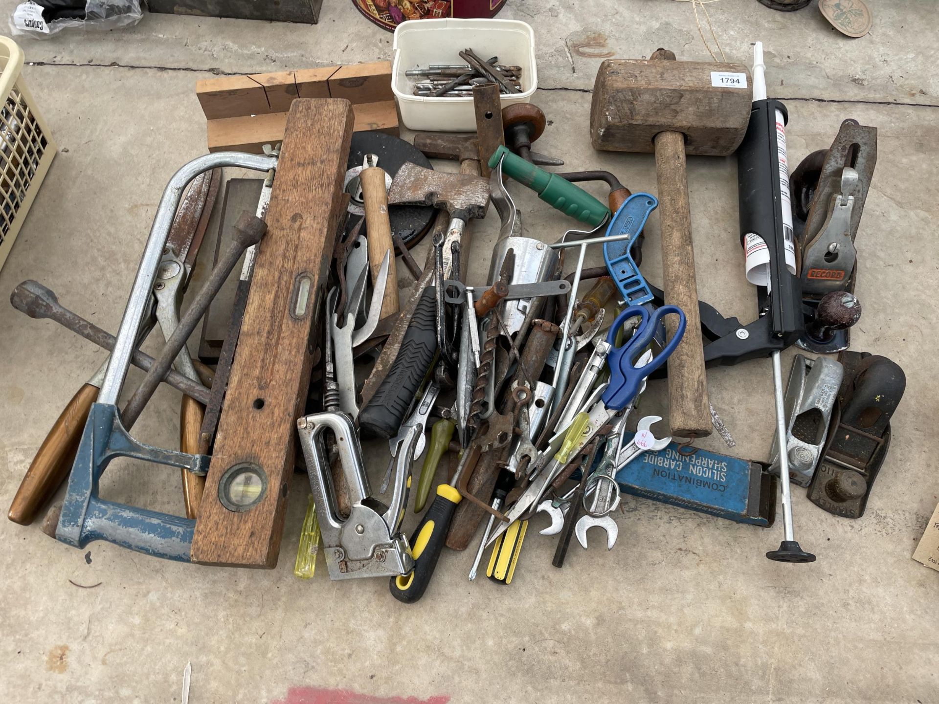 A LARGE ASSORTMENT OF HAND TOOLS TO INCLUDE SPANNERS, AN AXE AND WOOD PLANES ETC