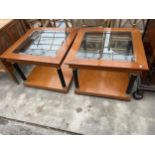 A PAIR OF SELVA STYLE INTERNATIONAL (NO.3) TWO TIER LAMP TABLES WITH INSET GLASS TOPS ON TURNED