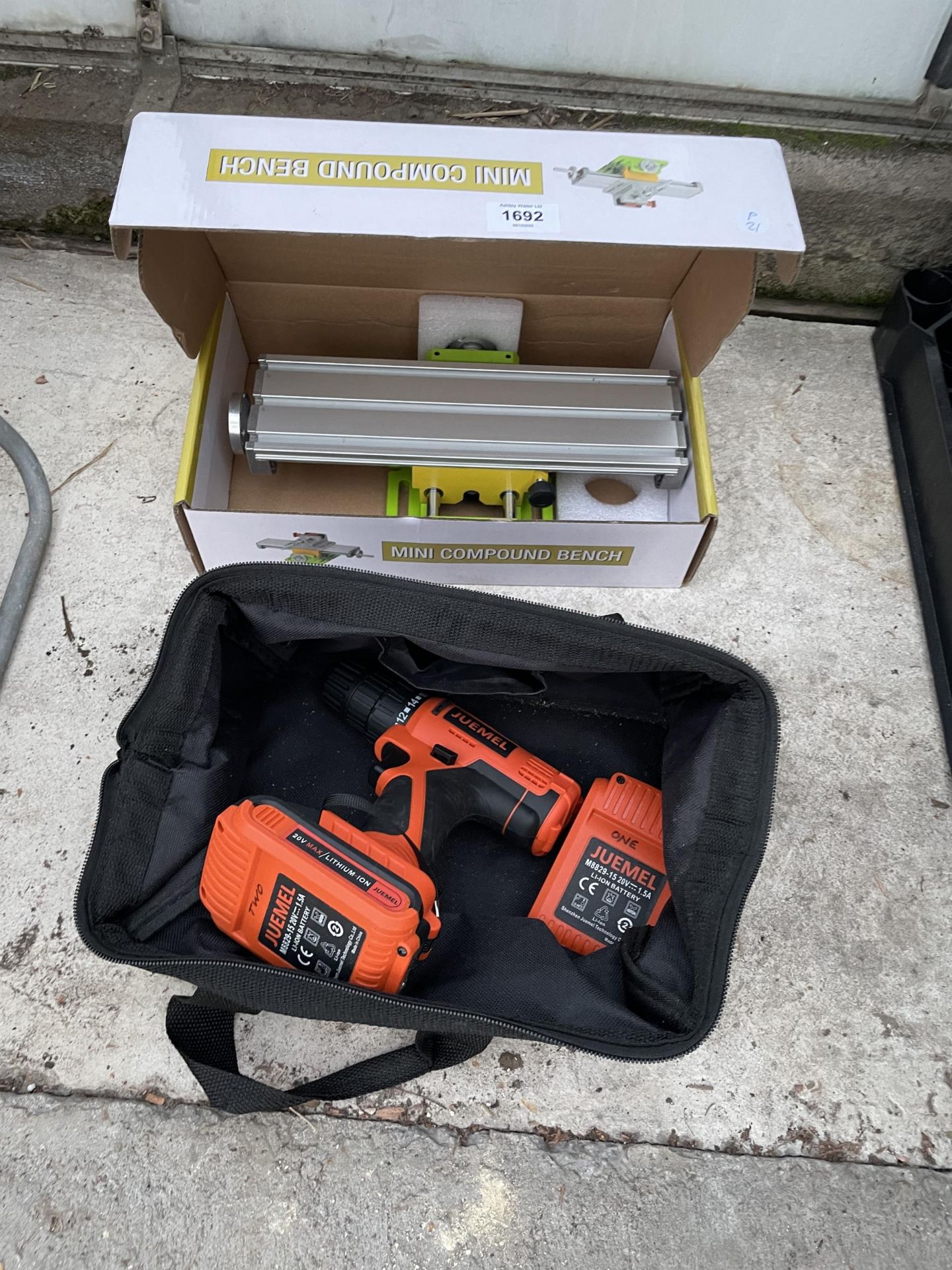 AN AS NEW BOXED MINI COMPOUND BENCH AND A JUEMEL BATTERY DRILL WITH TWO BATTERIES
