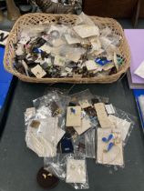 A WICKER BASKET OF ASSORTED COSTUME JEWELLERY IN BAGS AND BACKINGS