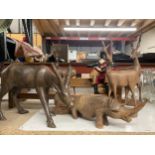 A COLLECTION OF CARVED WOODEN ANIMALS TO INCLUDE ANTELOPES, A RHINOCEROUS, ETC, A BOOK SHELF WITH
