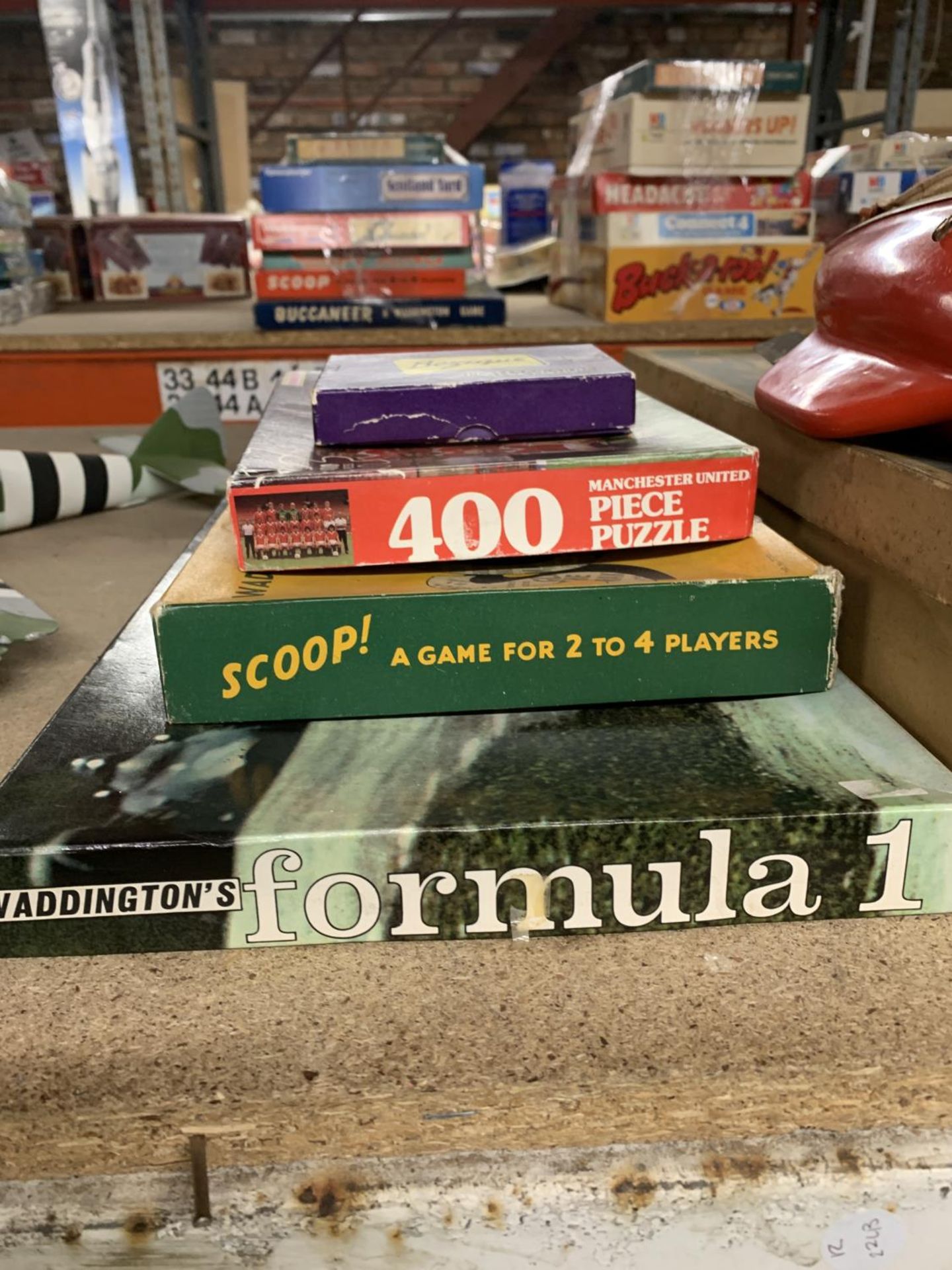 FOUR VINTAGE GAMES AND PUZZLES TO INCLUDE WADDINGTON'S FORMULA 1, SCOOP, BEZIQUE AND A MANCHESTER