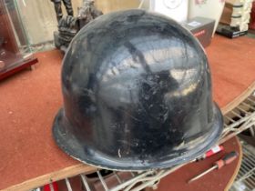 A VINTAGE MILITARY HELMET