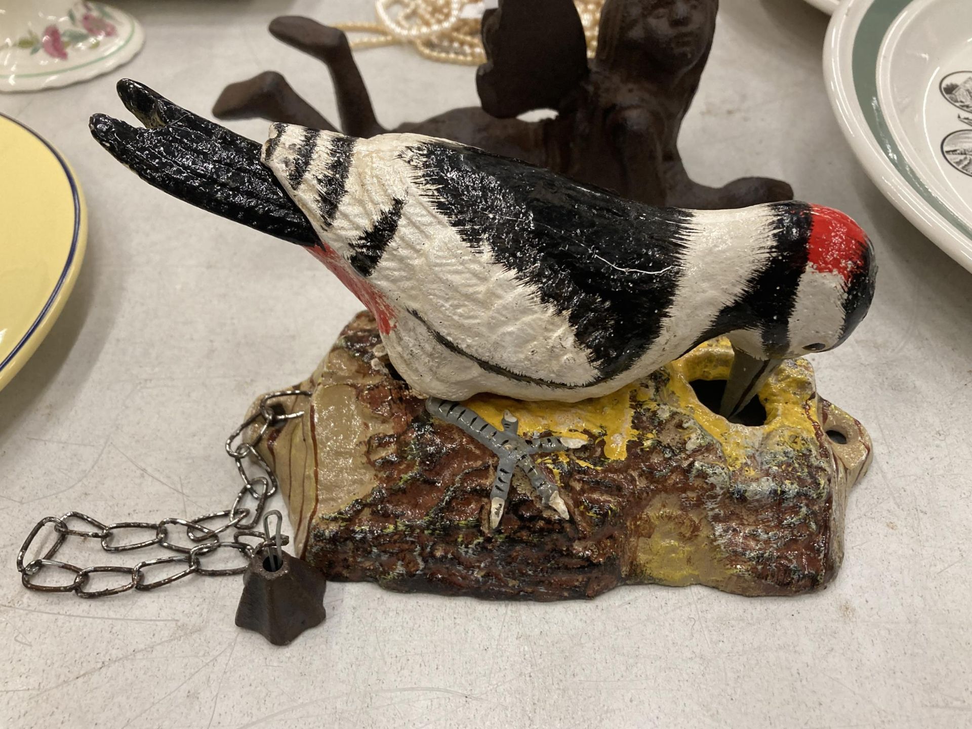 A PAINTED CAST METAL WOODPECKER DOOR BELL