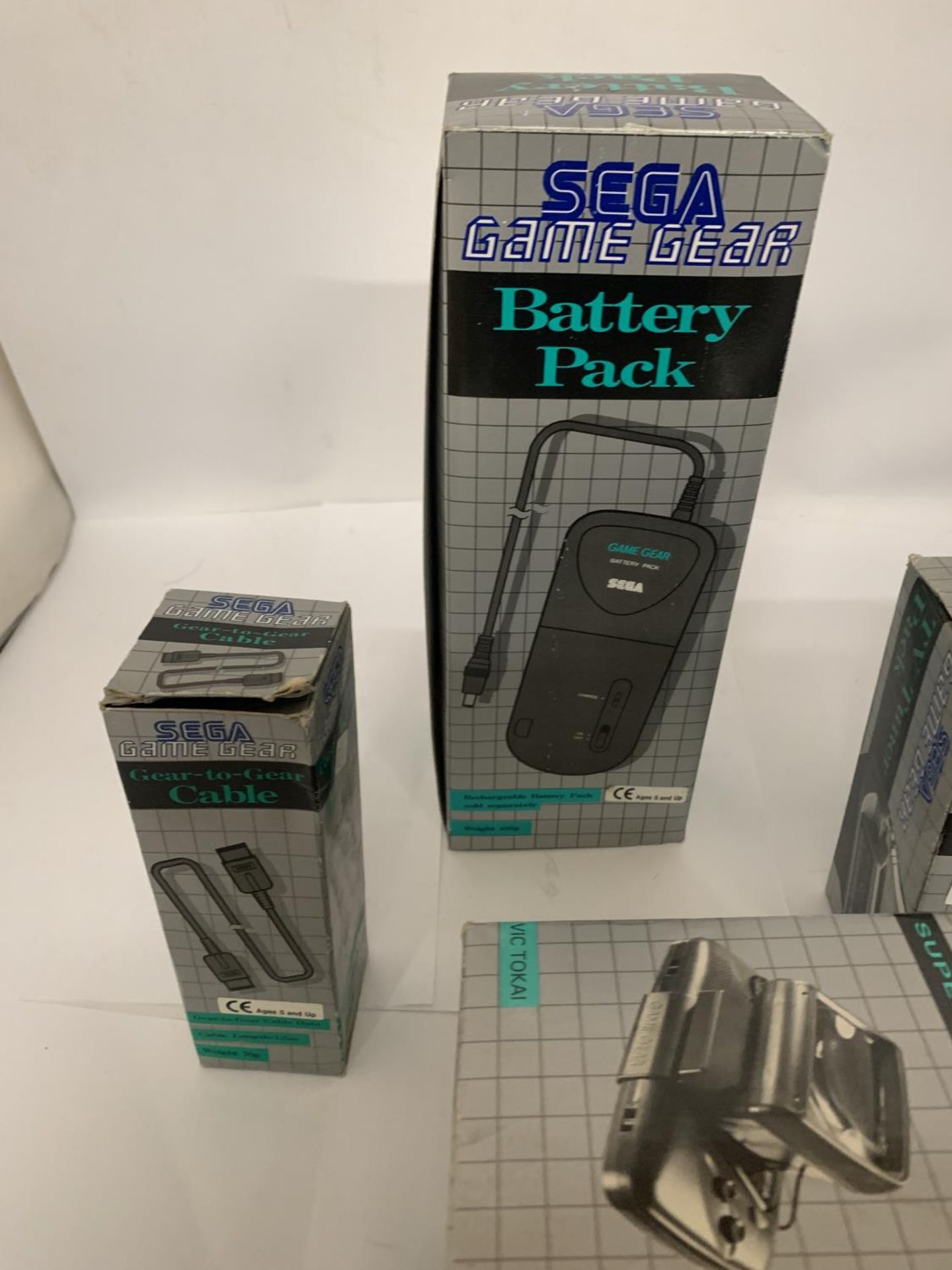 A SEGA GAME GEAR BATTERY PACK TOGETHER WITH A GEAR-TO-GEAR CABLE, MEGA POWER SUPER WIDE GEAR AND - Image 2 of 5