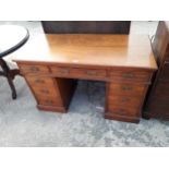 A LATE VICTORIAN MAHOGANY TWIN-PEDESTAL NINE DRAWER DESK, 42 X 22"