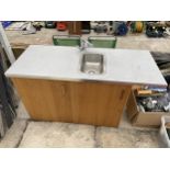 A WOODEN KITCHEN SINK UNIT WITH LOWER CUPBOARDS