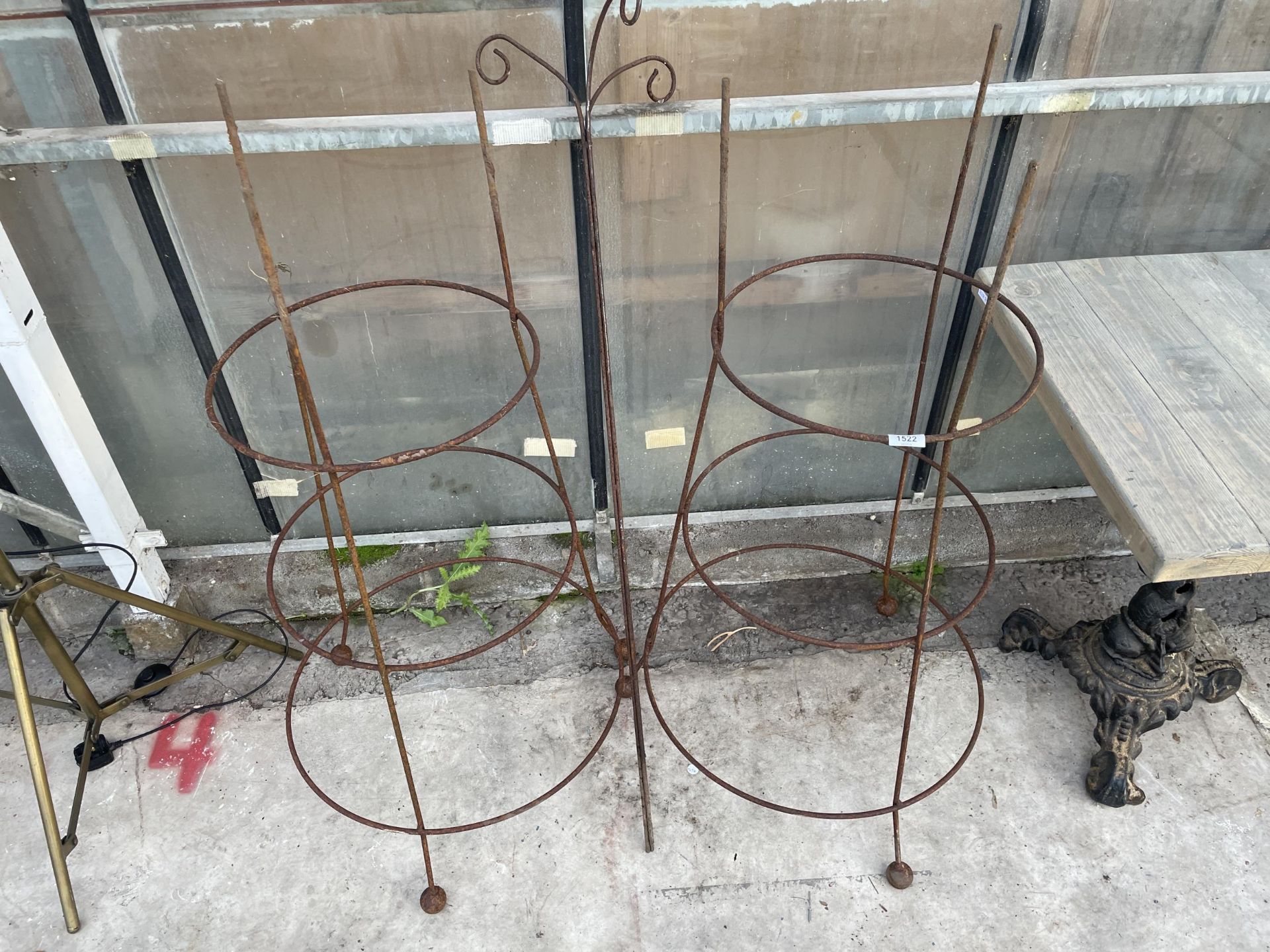 A PAIR OF STEEL PLANT CLIMBING FRAMES AND A STEEL BIRD FEEDER STAND