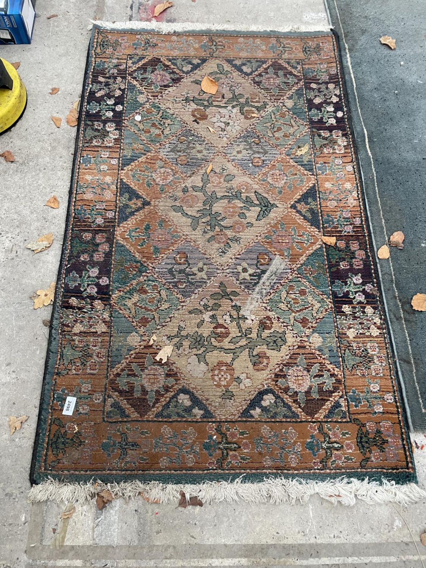 A SMALL PATTERNED FRINGE RUG