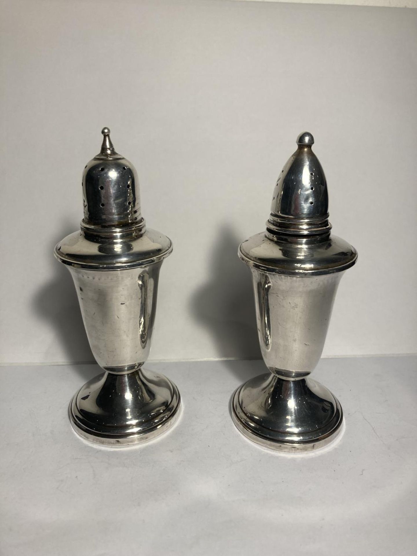 A PAIR OF MARKED CROWN STERLING SILVER CRUETS WITH GLASS LINERS