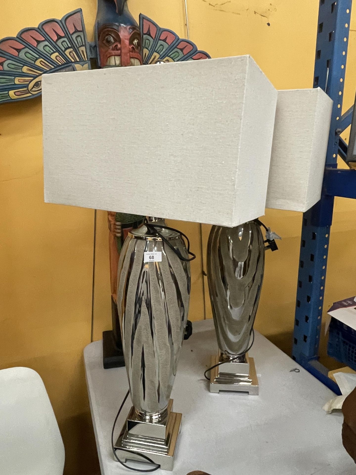 A PAIR OF DESIGNER MODERN FLOOR LAMPS ON CHROME EFFECT BASES WITH SHADES