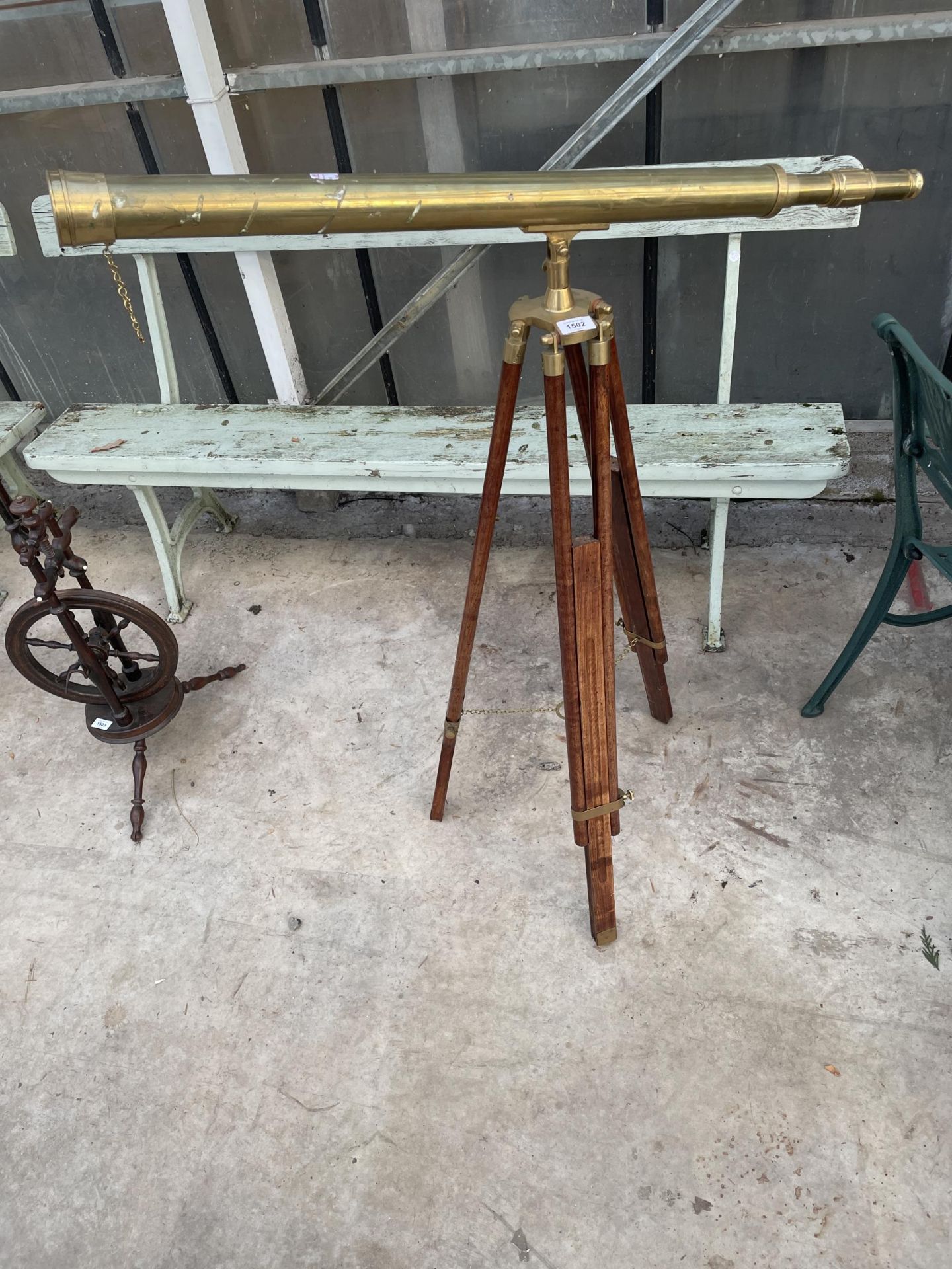 A VINTAGE BRASS TELESCOPE WITH WOODEN TRIPOD STAND