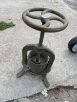 A VINTAGE BRASS FRUIT PRESS