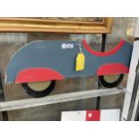 A WOODEN HAND PAINTED CAR SIGN (87CM X 35CM)