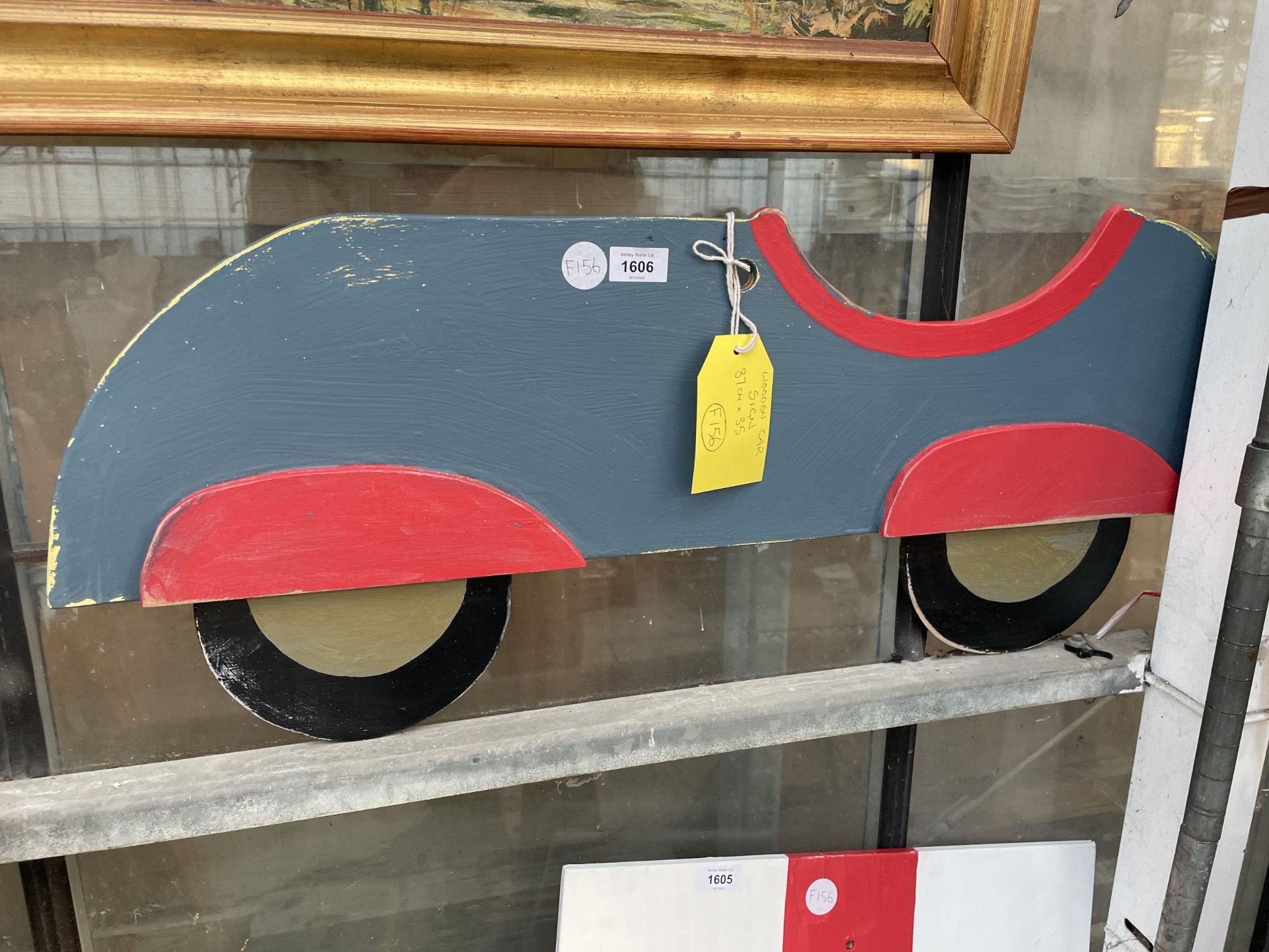 A WOODEN HAND PAINTED CAR SIGN (87CM X 35CM)