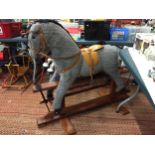 A VINTAGE PEGASUS GREY COLOURED ROCKING HORSE, IN GOOD CONDITION