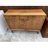 A GORDON RUSSELL ELLIPSES RETRO TEAK SIDEBOARD ENCLOSING TWO DRAWERS AND TWO CUPBOARDS WITH CIRCULAR