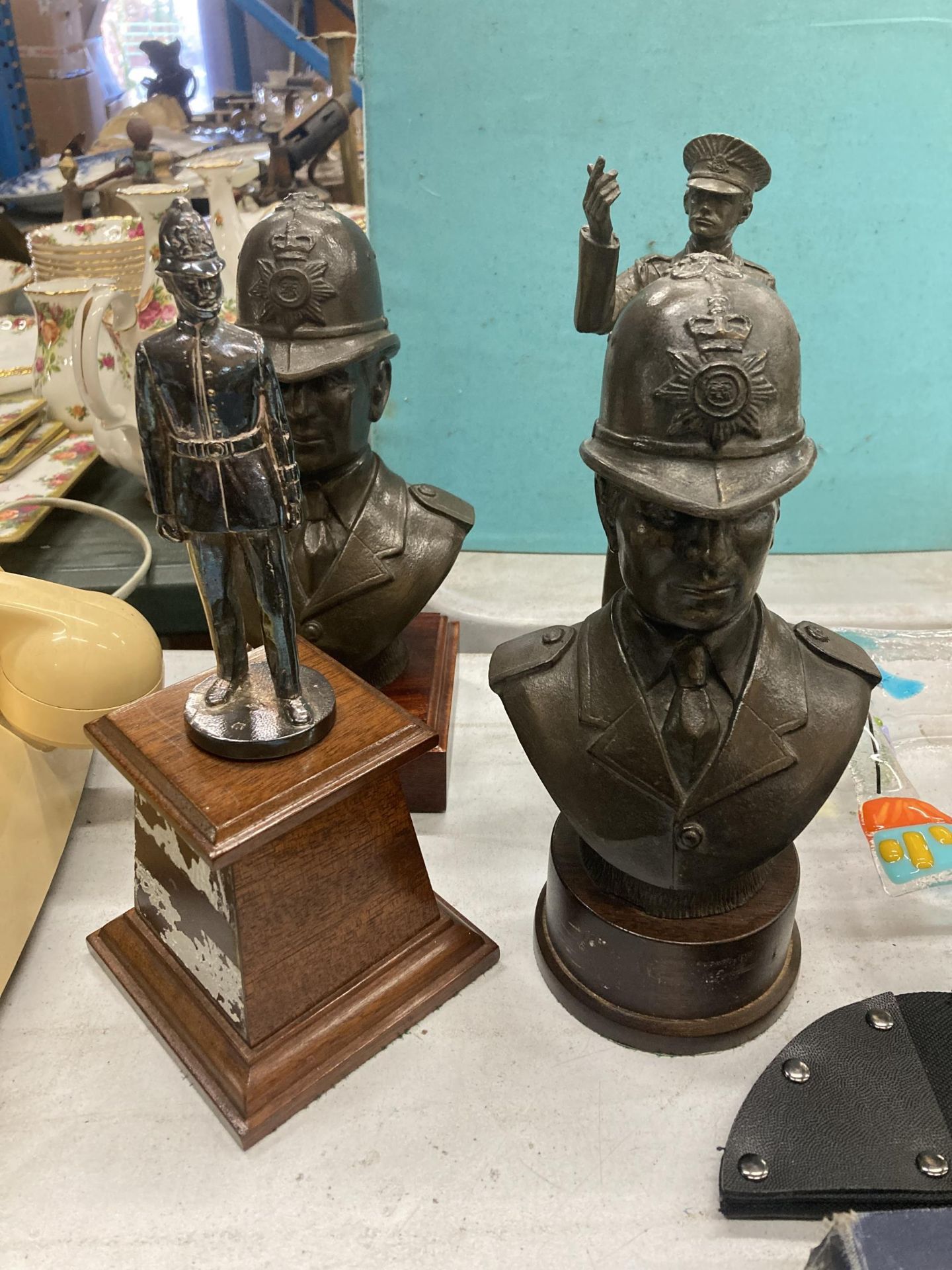 A GROUP OF POLICEMAN STATUE BUSTS