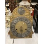 AN ANTIQUE BRASS GRANDFATHER CLOCK FACE AND MOVEMENT