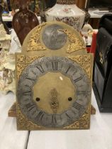 AN ANTIQUE BRASS GRANDFATHER CLOCK FACE AND MOVEMENT