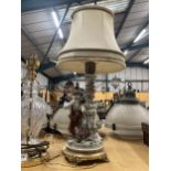 AN ITALIAN FIGURAL POTTERY TABLE LAMP AND SHADE ON GILT METAL BASE