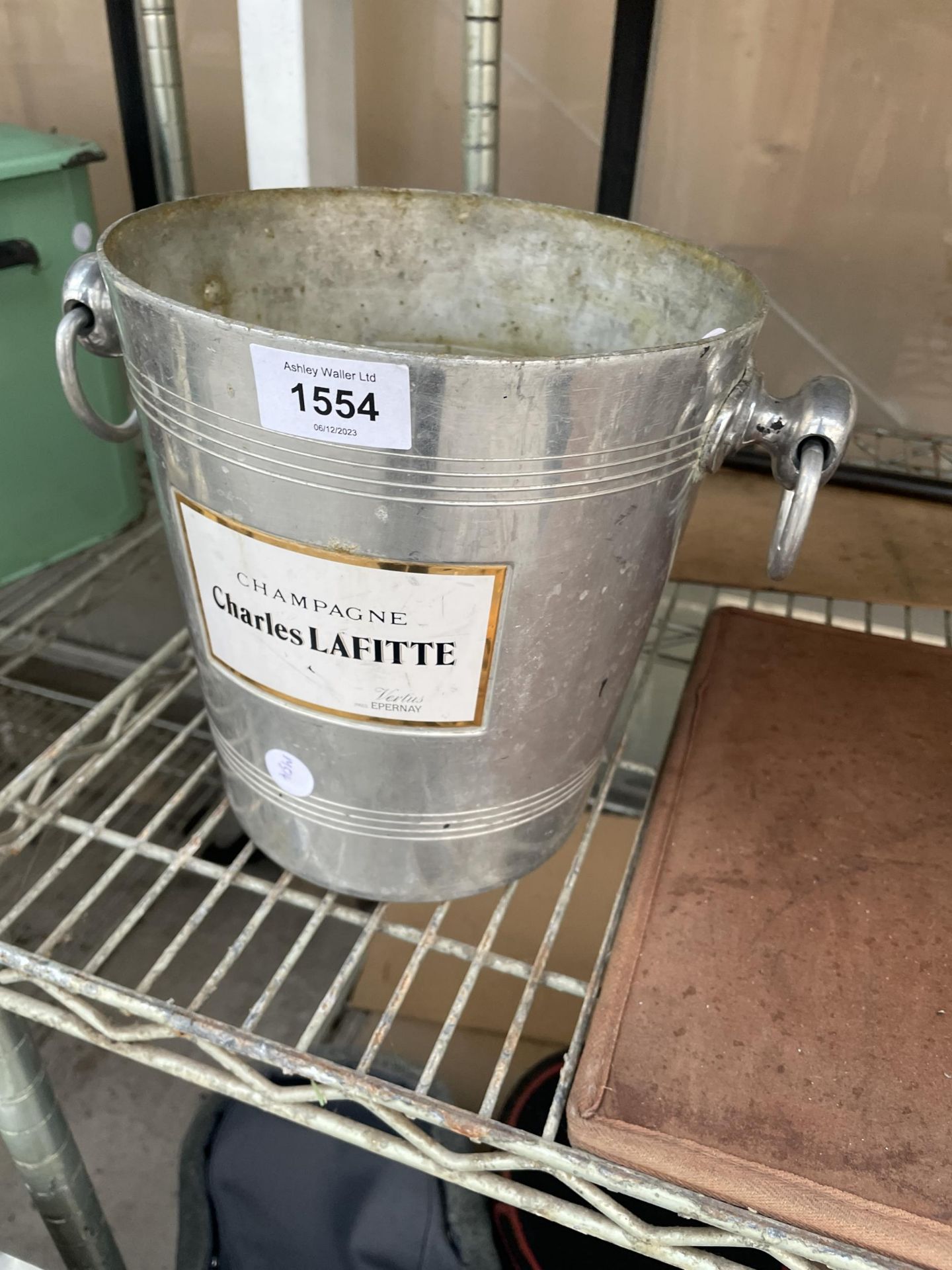 AN ICE BUCKET BEARING THE LABEL 'CHAMPAGNE CHARLES LAFITTE
