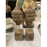 A PAIR OF DECORATIVE STONE BUDDHA HEADS ON STANDS, HEIGHT 30CM