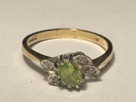 A 9 CARAT GOLD RING WITH A CENTRE PERIDOT SURROUNDED BY DIAMONDS IN A LEAF DESIGN SIZE O/P