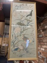 A LARGE FRAMED ORIENTAL STYLE NEEDLEWORK ON SILK PICTURE OF A LAKE SCENE WITH DUCKS, BIRDS AND FLORA