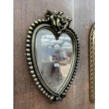 A MODERN HEART SHAPED WALL MIRROR