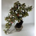 A LARGE AND IMPRESSIVE ORIENTAL MODEL OF A BONSAI TREE WITH GREEN GLASS LEAVES AND PINK FRUIT