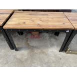 AN INDUSTRIAL STYLE TABLE ON CST METAL AND STUDDED LEGS AND FRAME, WITH WOODBLOCK TOP, 47 X 28"