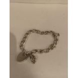 A SILVER BRACELET WITH ROSE CHARM AND A HEART PADLOCK