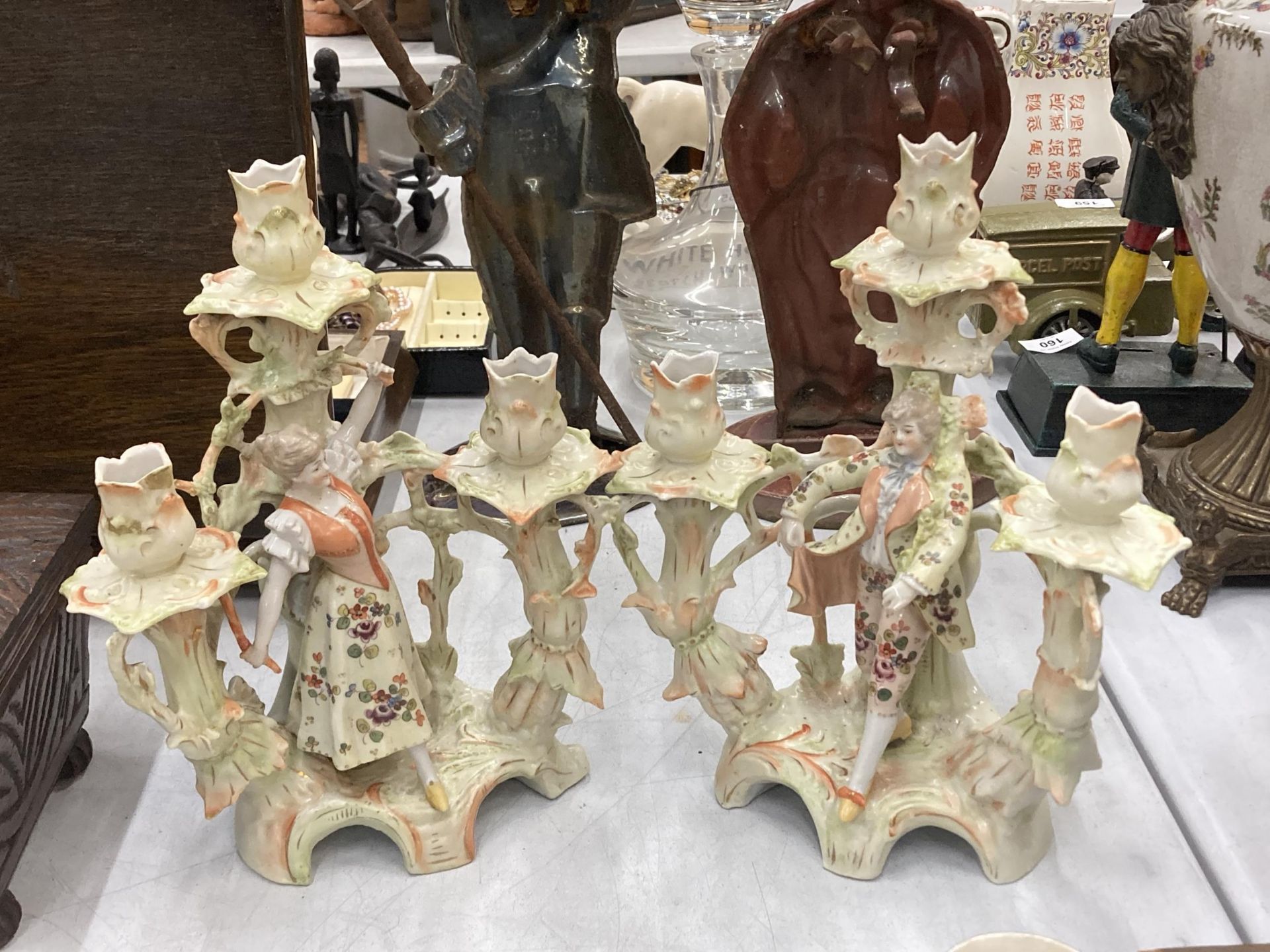 A PAIR OF CONTINENTAL PORCELAIN FIGURAL CANDLESTICKS