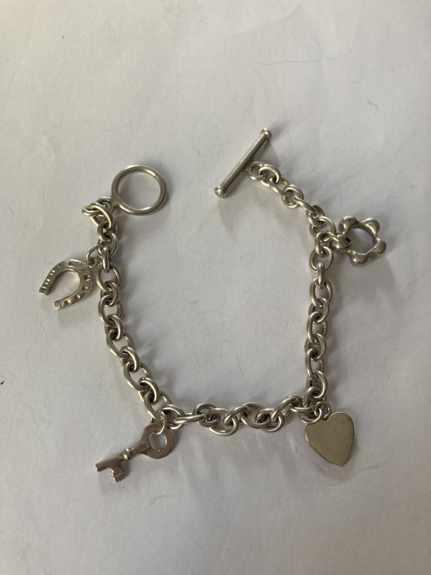 A SILVER T-BAR CHARM BRACELET