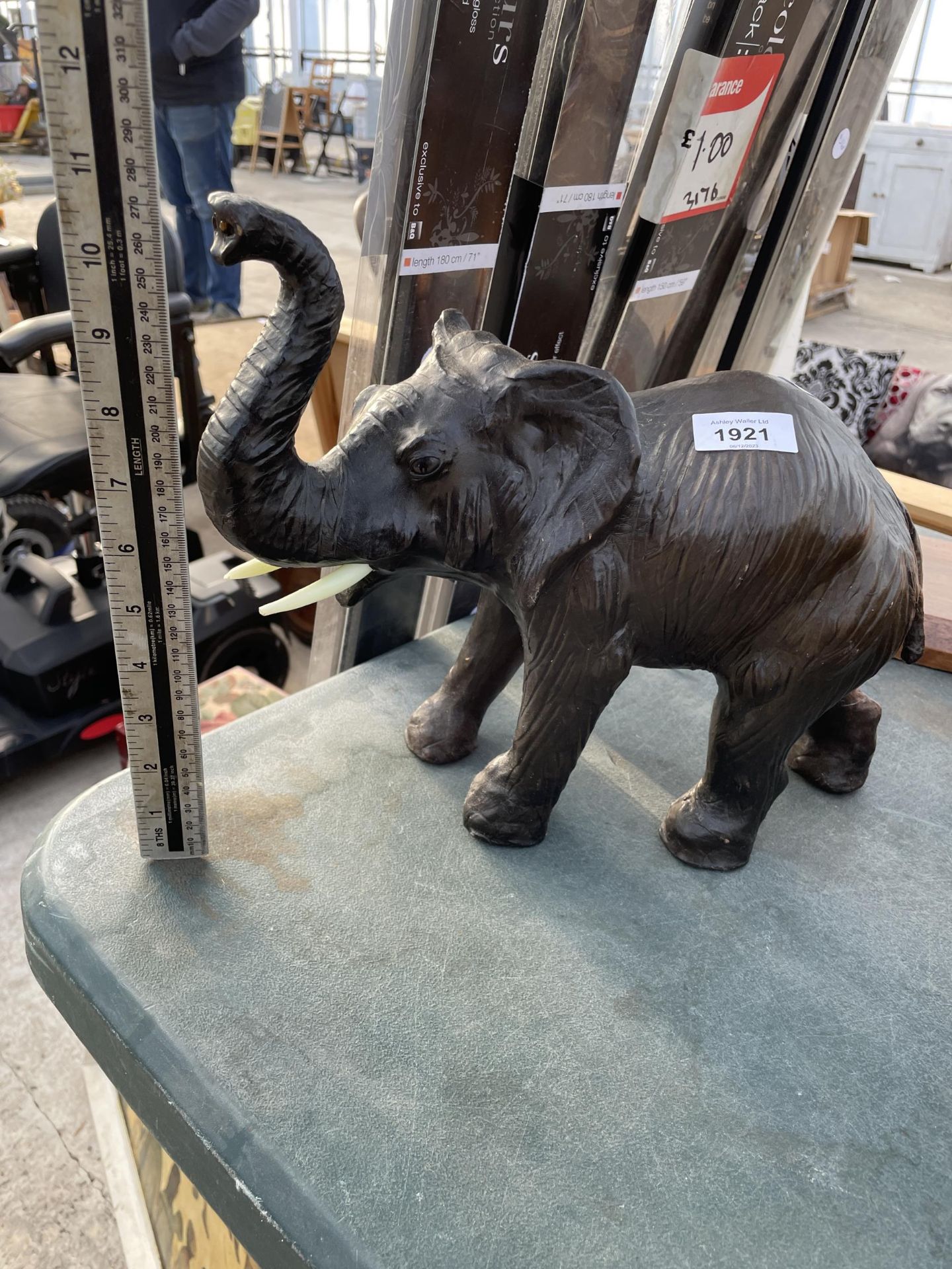 A MINIATURE DECORATIVE LEATHER BOUND ELEPHANT