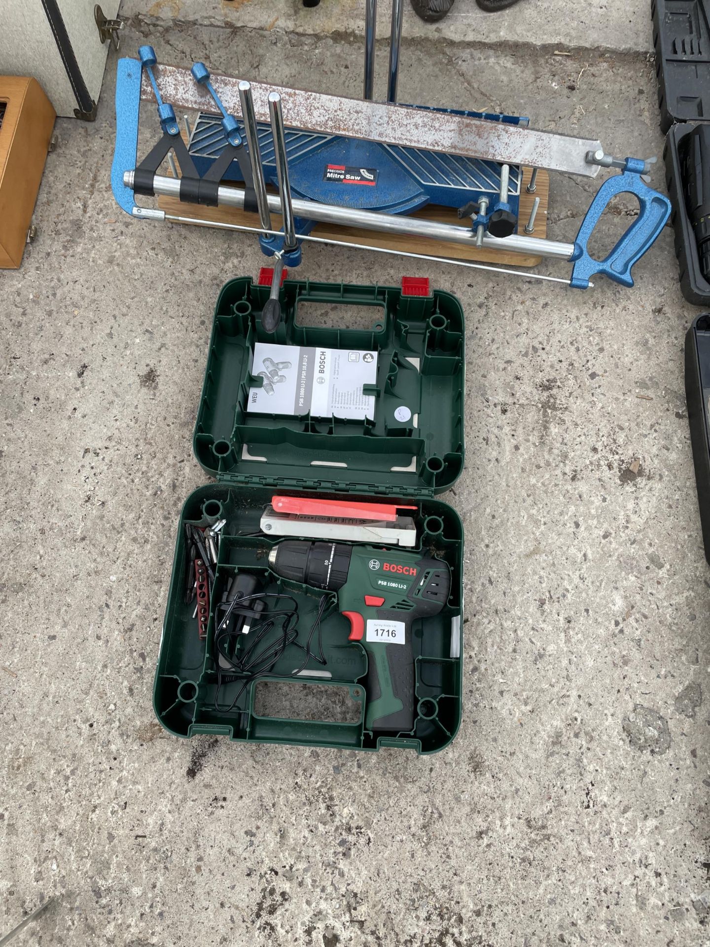 AN AS NEW AND BOXED BOSCH ELECTRIC SCREW DRIVER AND A MITRE SAW