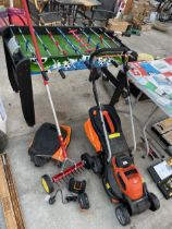 A YARD FORCE BATTERY POWERED LAWN MOWER AND A GRASS SLITTER