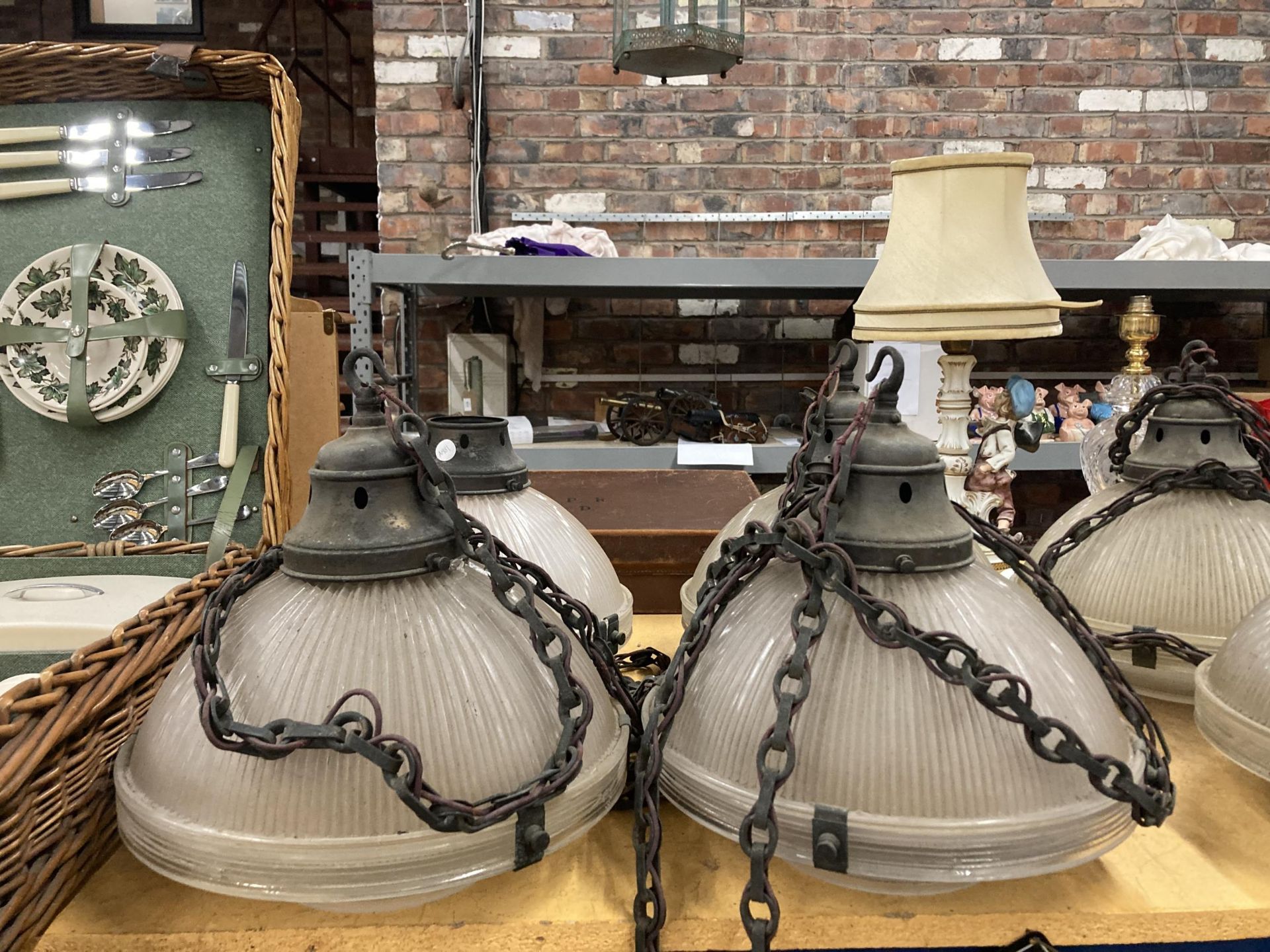 A SET OF FOUR HOLOPHANE LAMPS WITH METAL FITTINGS AND CHAIN