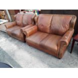 A PAIR OF MODERN BROWN LEATHER AND STUDDED TWO SEATER SETTEE