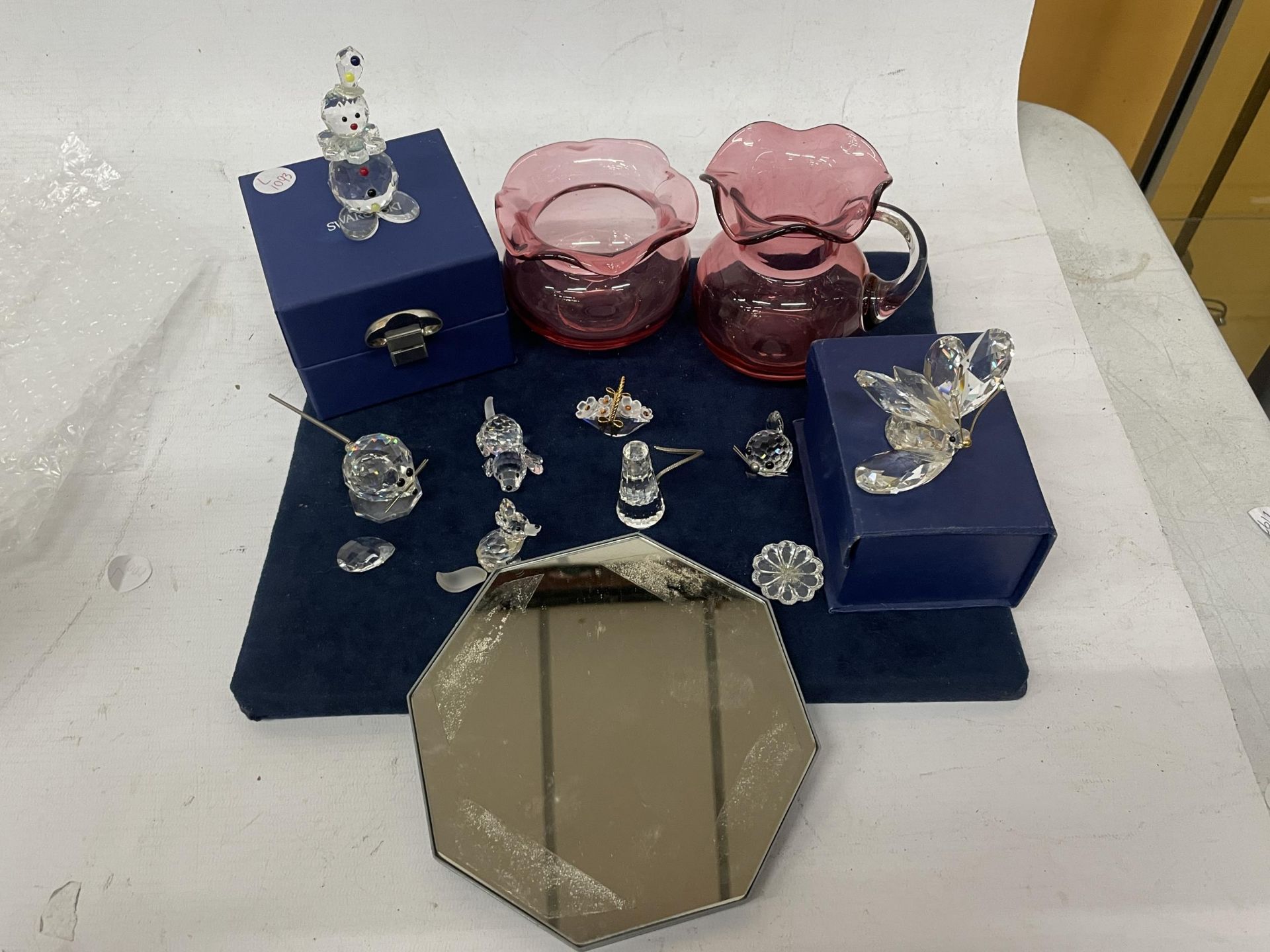 A COLLECTION OF SWAROVSKI CRYSTAL ORNAMENTS, SOME BOXED AND CRANBERRY GLASS ITEMS