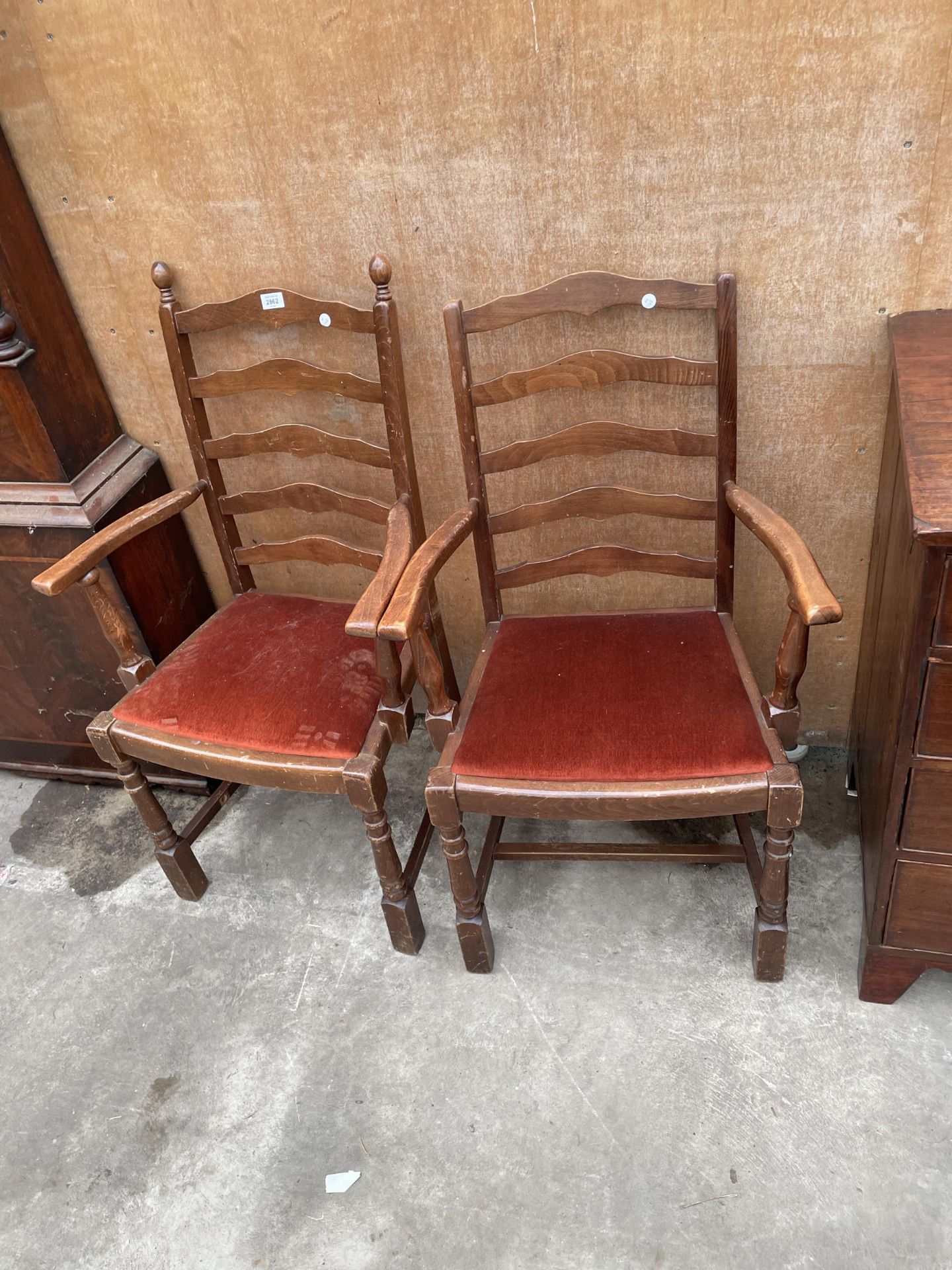 A PAIR OF LADDERBACK CARVER CHAIRS