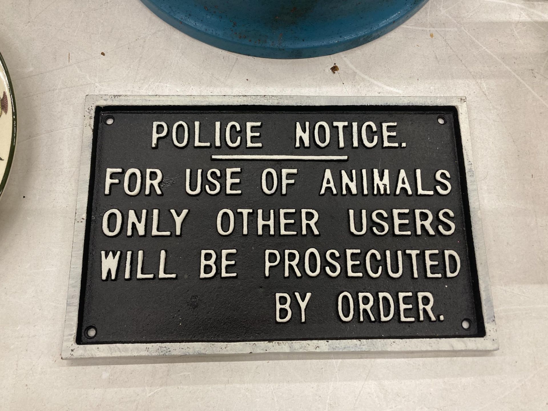 A CAST POLICE NOTICE SIGN