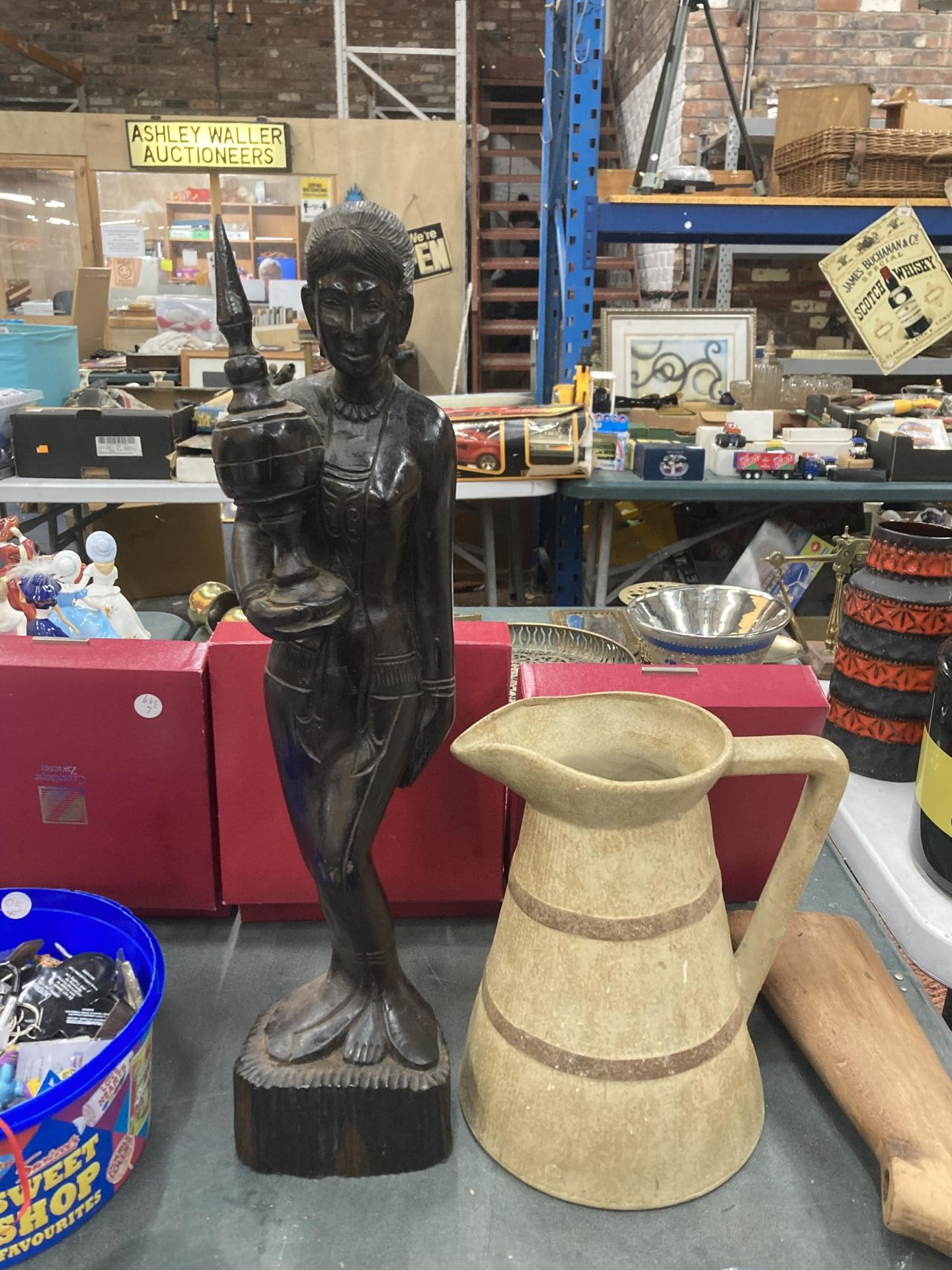 TWO ITEMS - CARVED WOODEN TRIBAL FIGURE AND A DEE CEE JUG