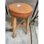 A FOUR LEGGED PINE STOOL WITH LEATHER SEAT