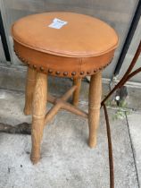 A FOUR LEGGED PINE STOOL WITH LEATHER SEAT