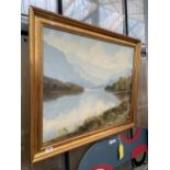 A GILT FRAMED OIL ON CANVAS OF A LAKE SCENE